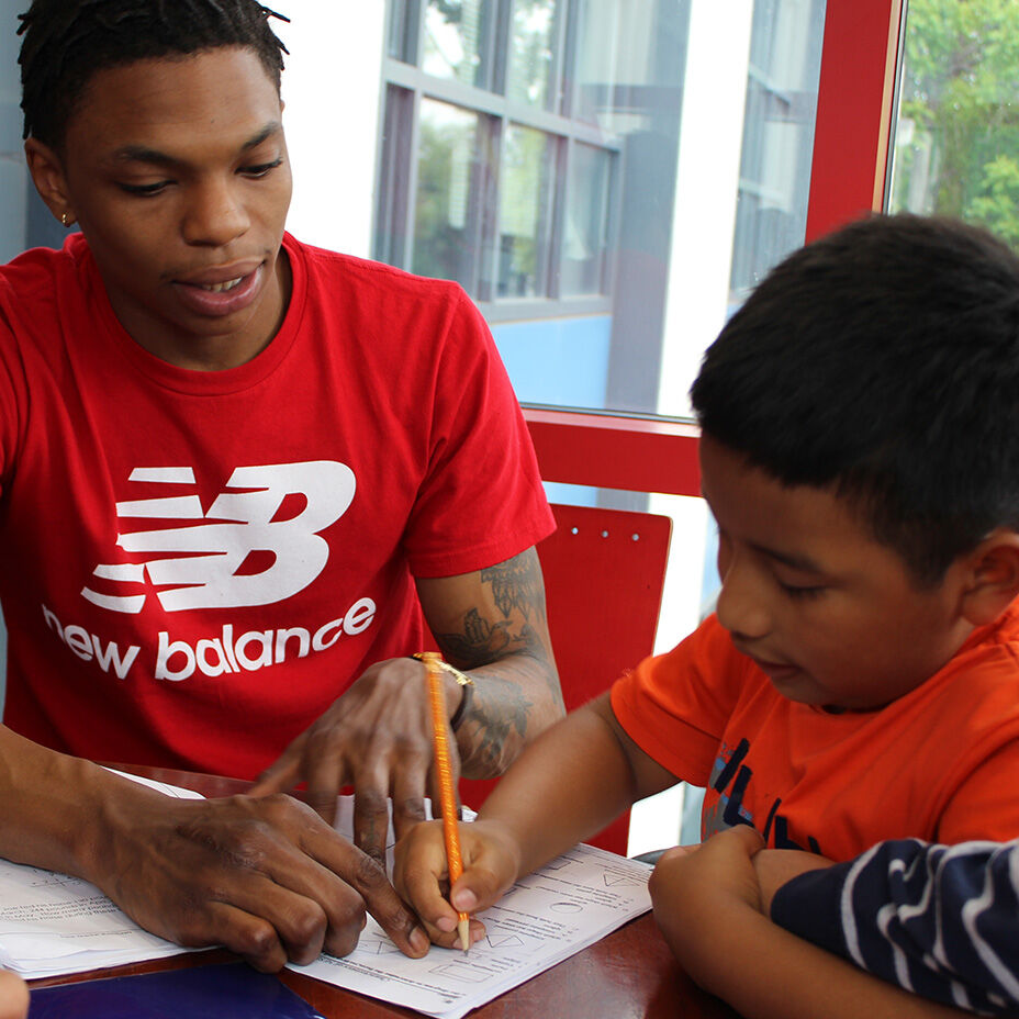 Employee assisting kid with homework