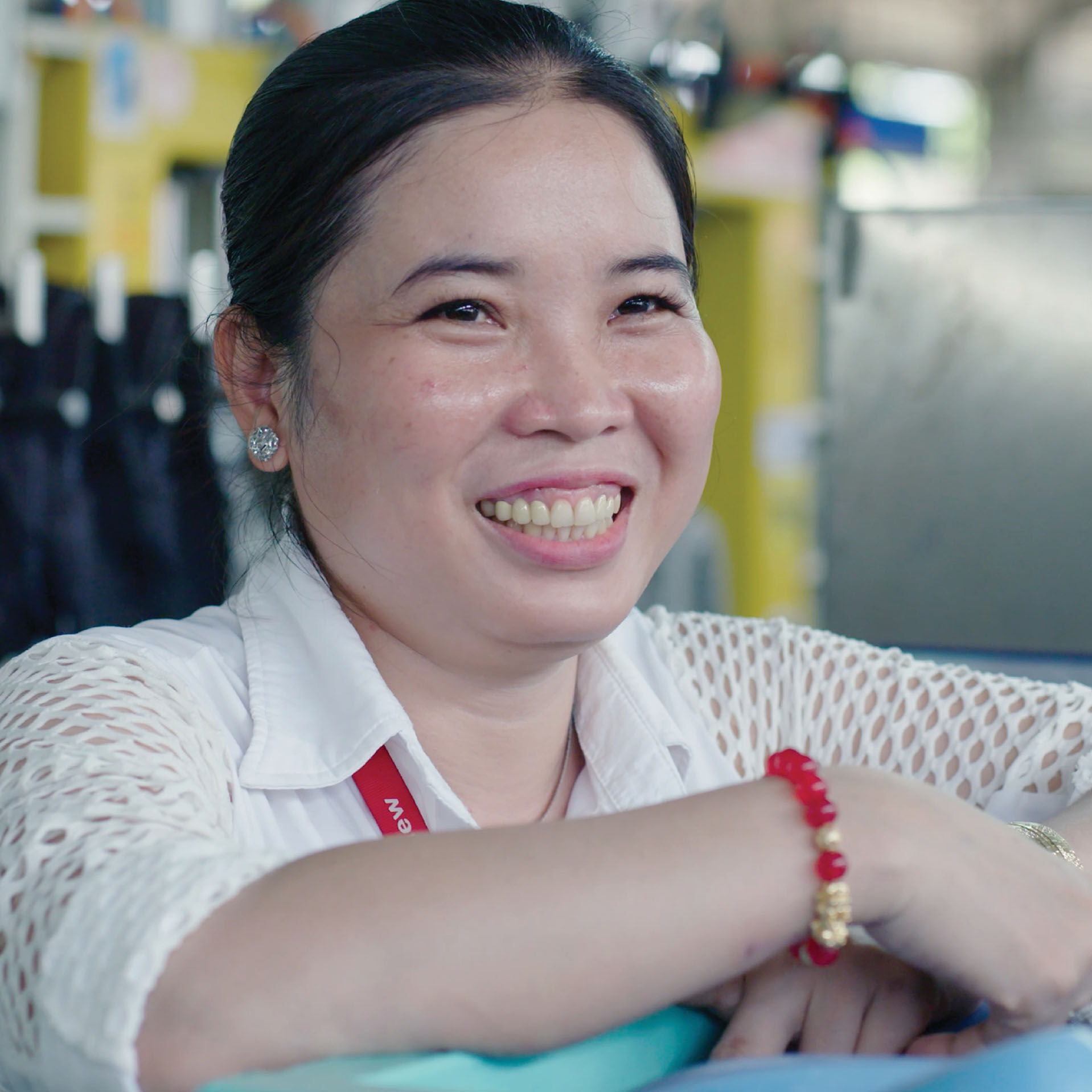 Female factory worker smiling and posing for photo